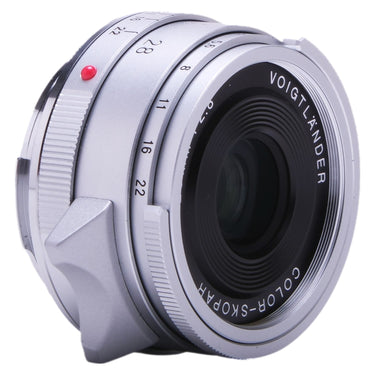Voigtlander Color-Skopar 28mm silver lens angled front view with red index dot